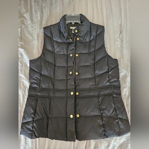 Black puffer vest with gold accent